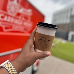 a person holding a cup of coffee