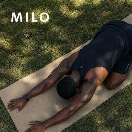 a man doing yoga in a park