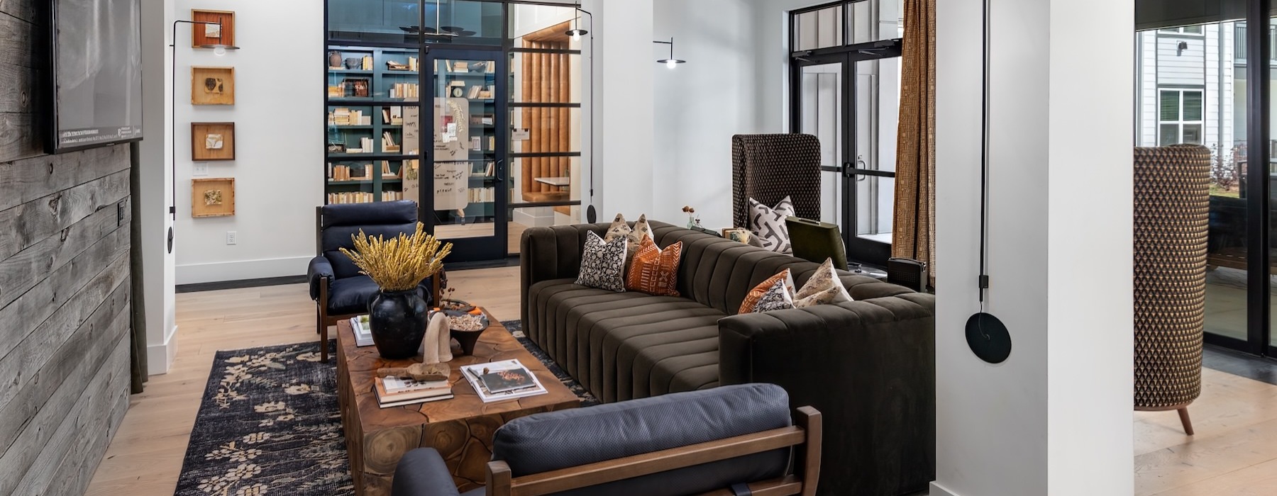 a clubroom with a couch, chairs and a tv