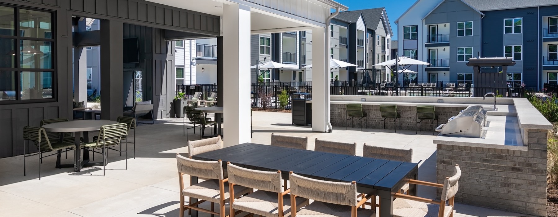 a patio with tables and chairs