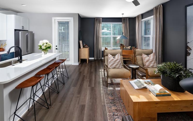a kitchen and living room with tables and chairs