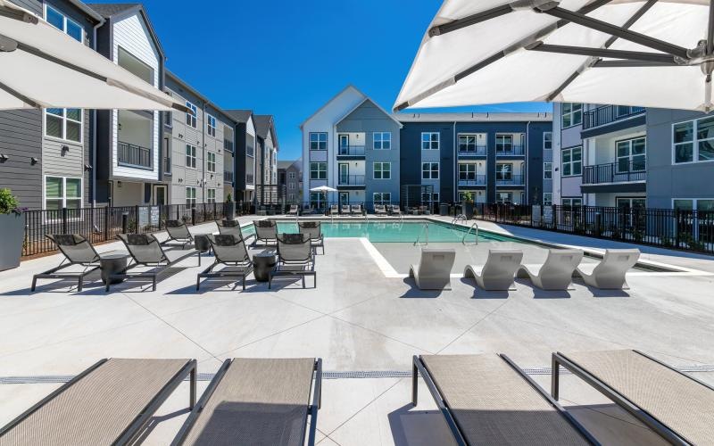 a pool with lounge chairs
